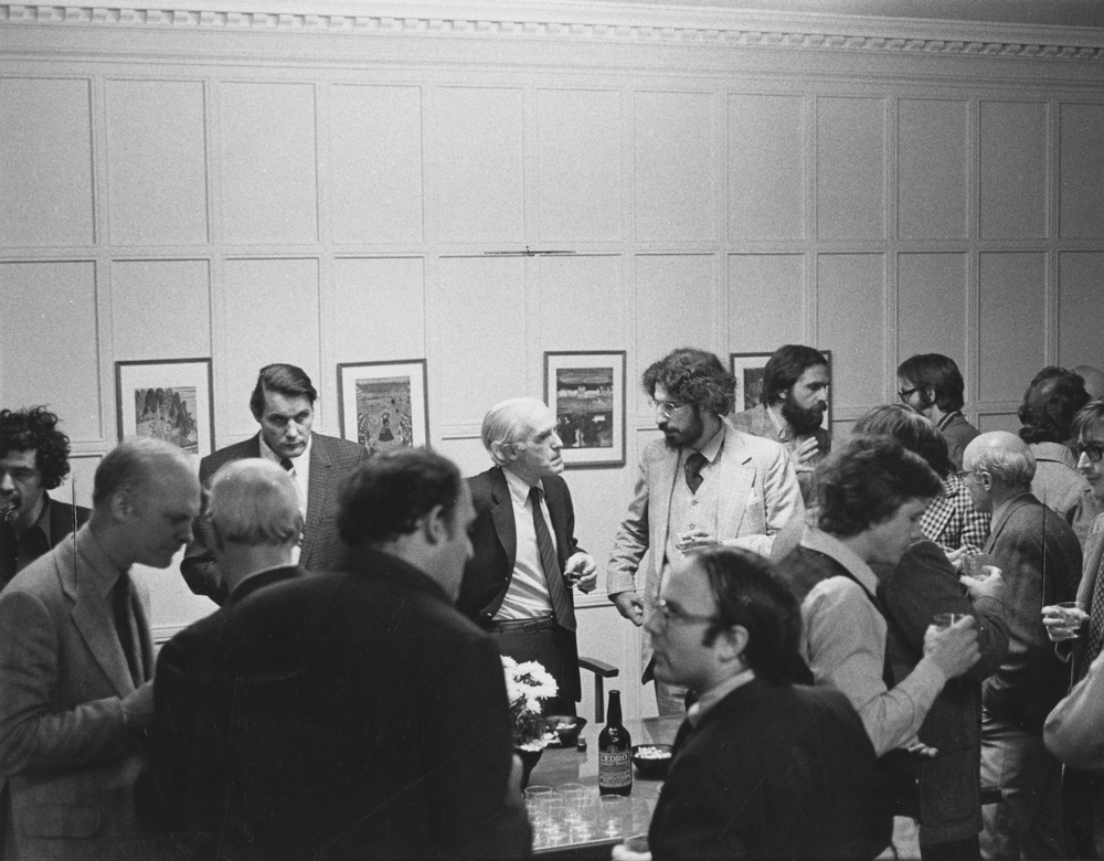 John T. Wilson (center left), president of the University of Chicago (1975-1978), talking to Smith. | Undated