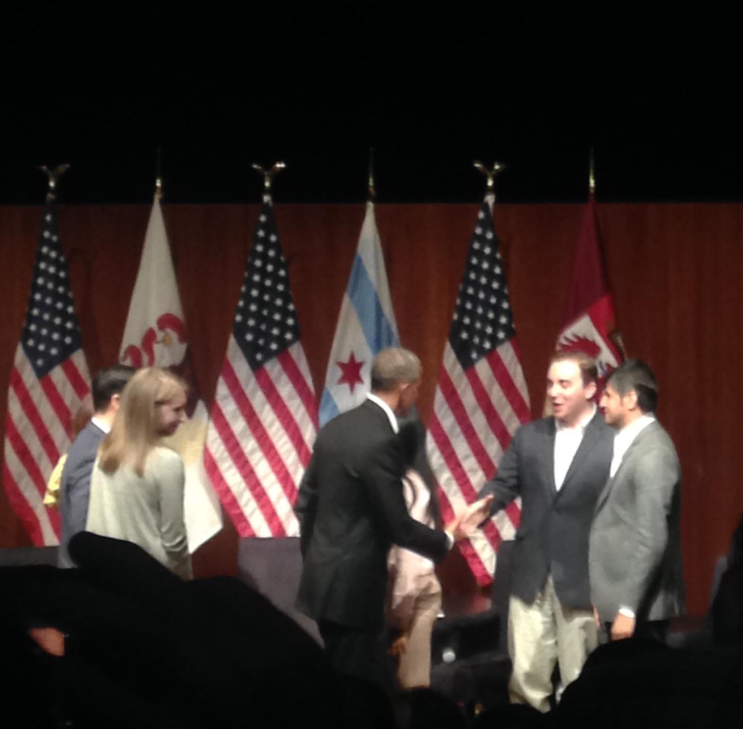 Obama shook hands with panelists and then with members of the audience following the event.