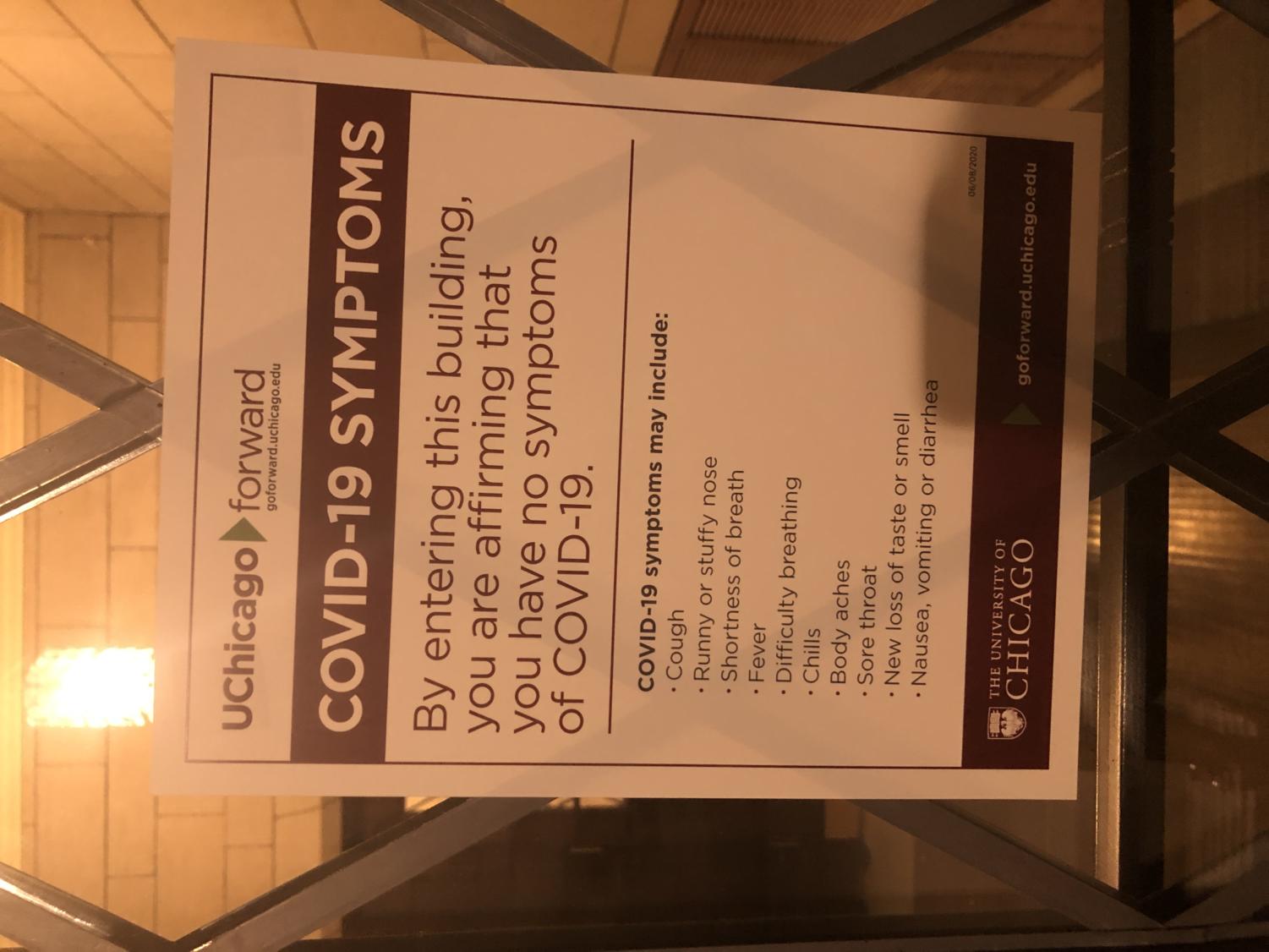 A UChicago-produced flyer on the door of the Social Science Research Building says that those entering are affirming they have no COVID-19 symptoms.