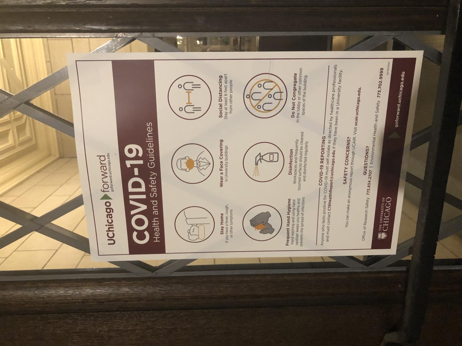 A University-produced flyer on the door of the Social Science Research Building shares “COVID-19 Health and Safety Guidelines,” including social distancing.