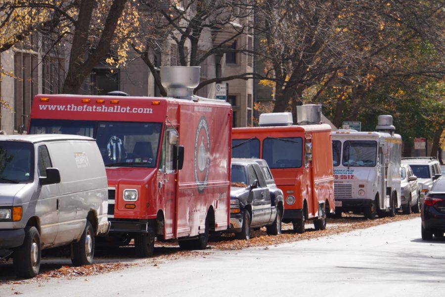On Ellis Ave, five trucks with two red food trucks