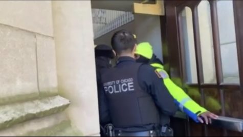 A UChicago Safety Ambassador opens an alarmed door at Cobb Hall, triggering a security alarm.