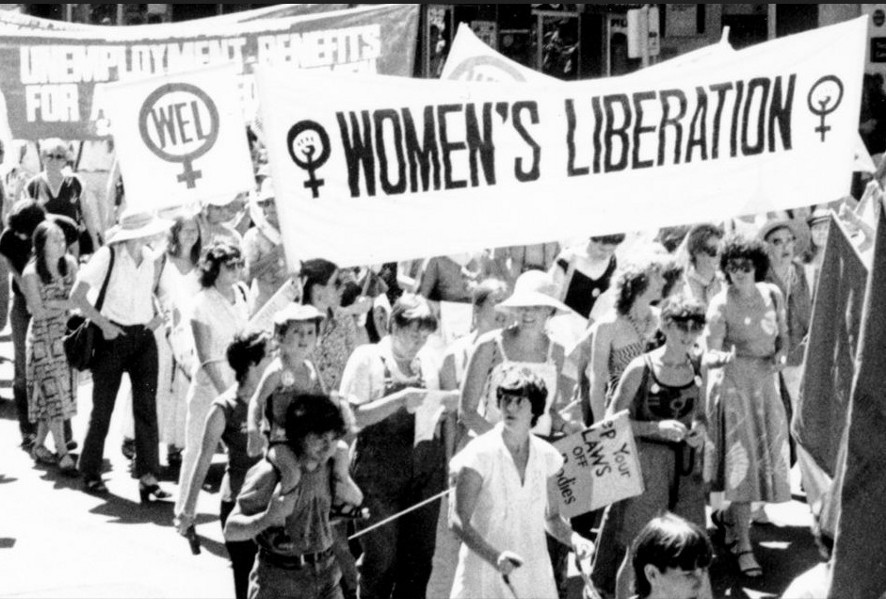A Womens Liberation march around 1970. Booth is at the bottom in white, pushing a stroller