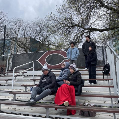 A small crowd gathers to watch the UChicago softball team take on Lake Forest at Stagg Field.