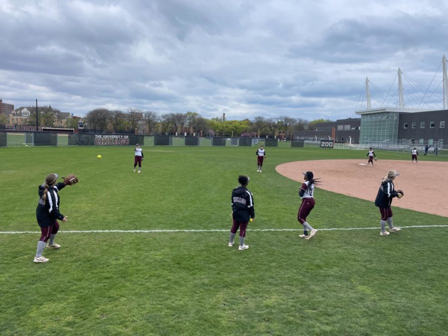 The softball team warms up before a game against Lake Forest College.
