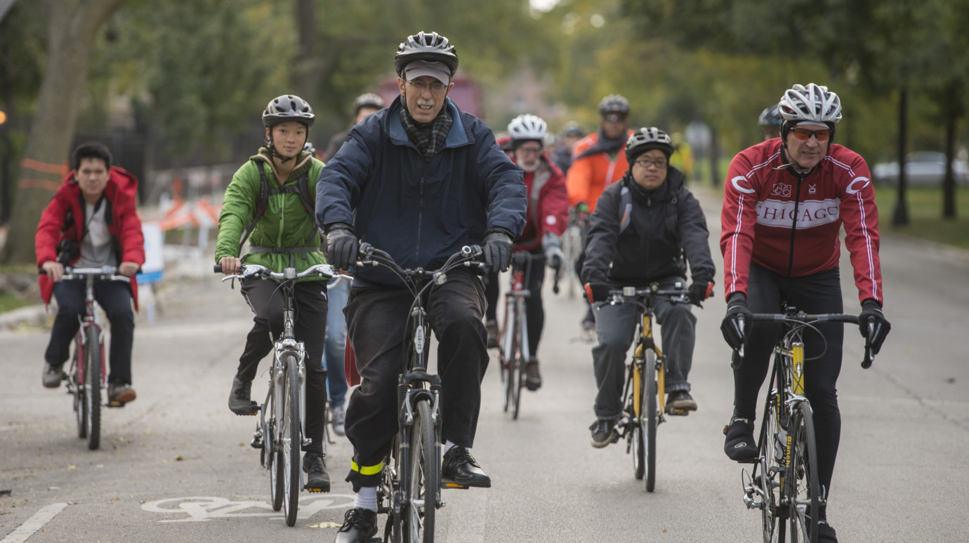 Boyer (center) and Political Science Professor Mark Hansen (right) lead a bike tour of the Southside