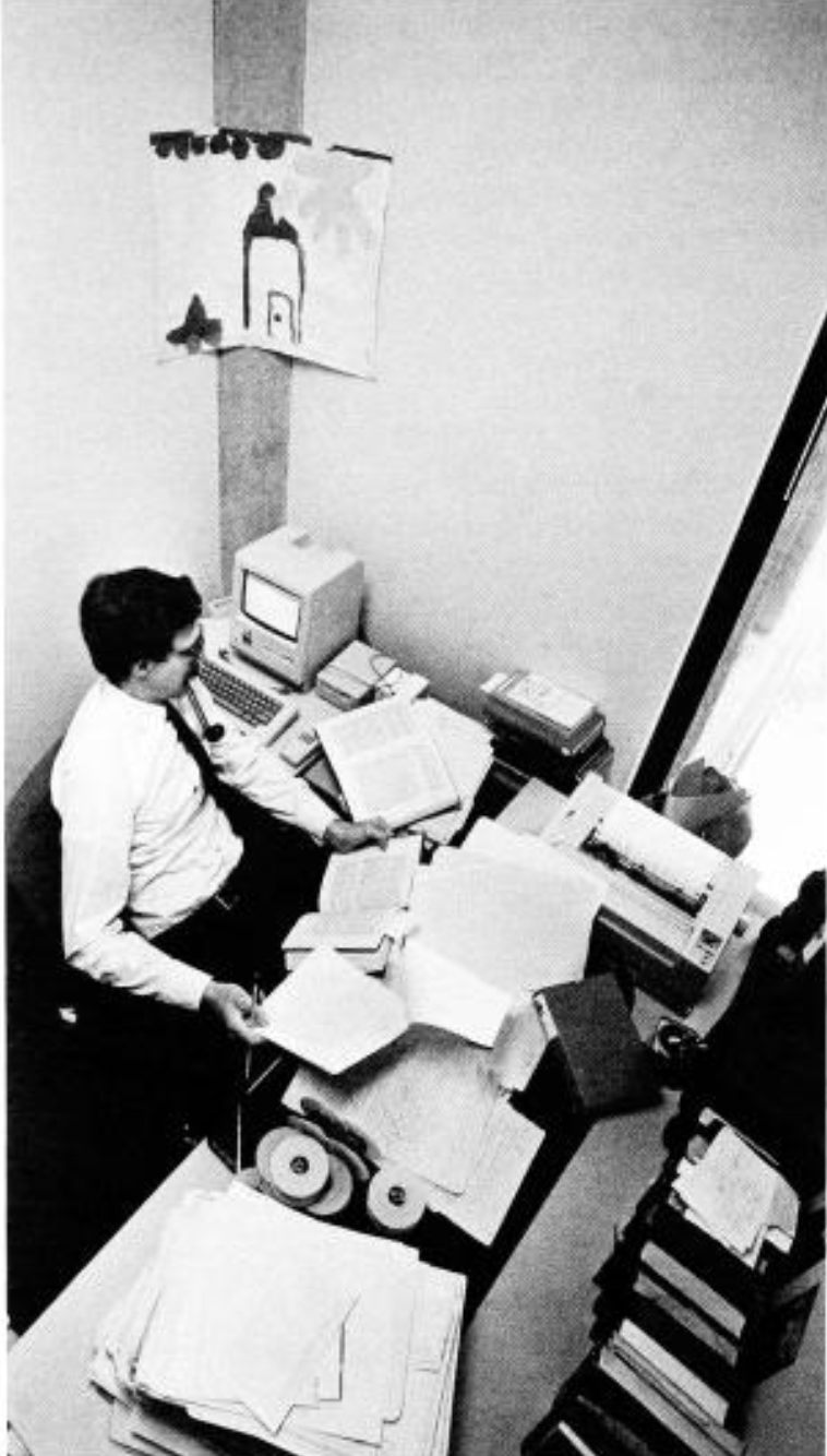 Boyer admires his Macintosh computer