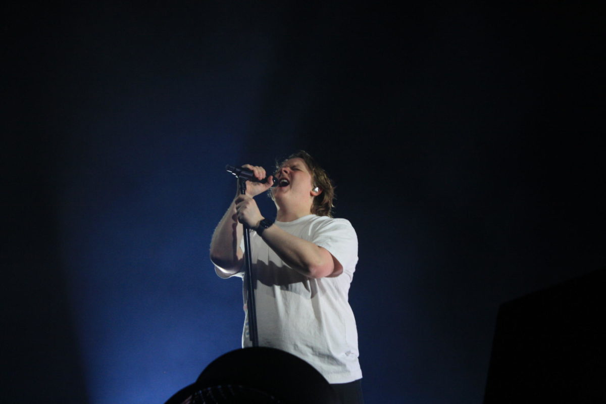 In a simple white T-shirt and black jeans, [Lewis Capaldi] leaned into the audience, his hair seemingly blowing in the breeze.