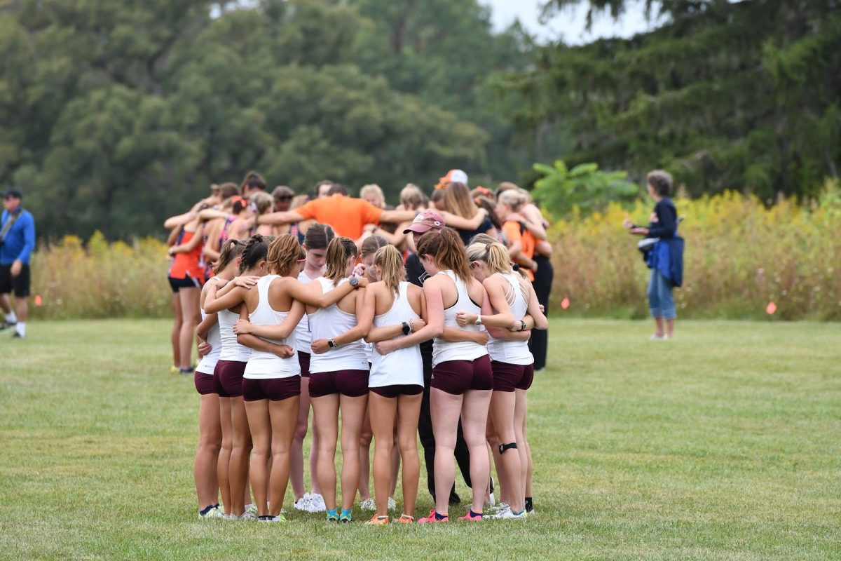 The Maroons in a huddle before the Wheaton Gil Dodds Invitational.