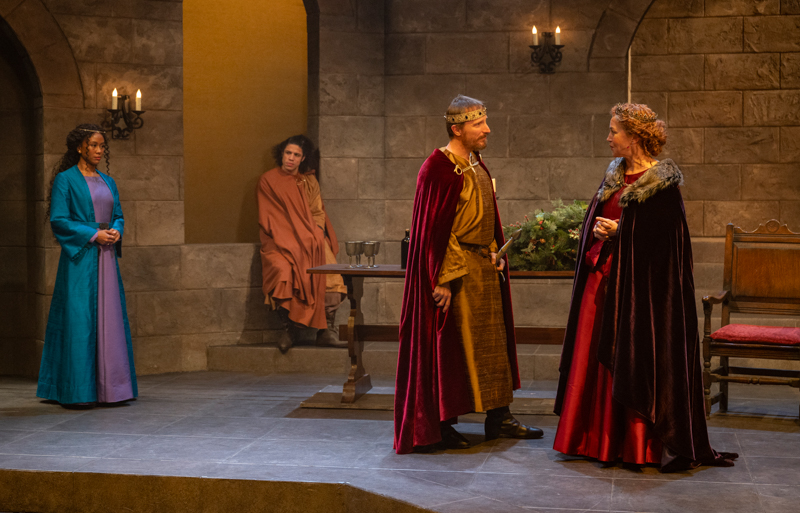 In The Lion in Winter, Henry (John Hoogenakker) and Eleanor (Rebecca Spense) negotiate while their youngest son and Henry’s mistress look on.