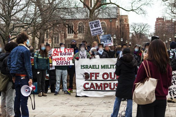 Protestors on the quad hold signs in support of Palestine and condemning Israel.
