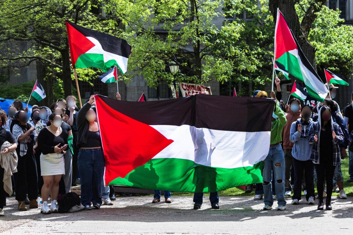 Protesters wave Palestinian flags during the encampment.