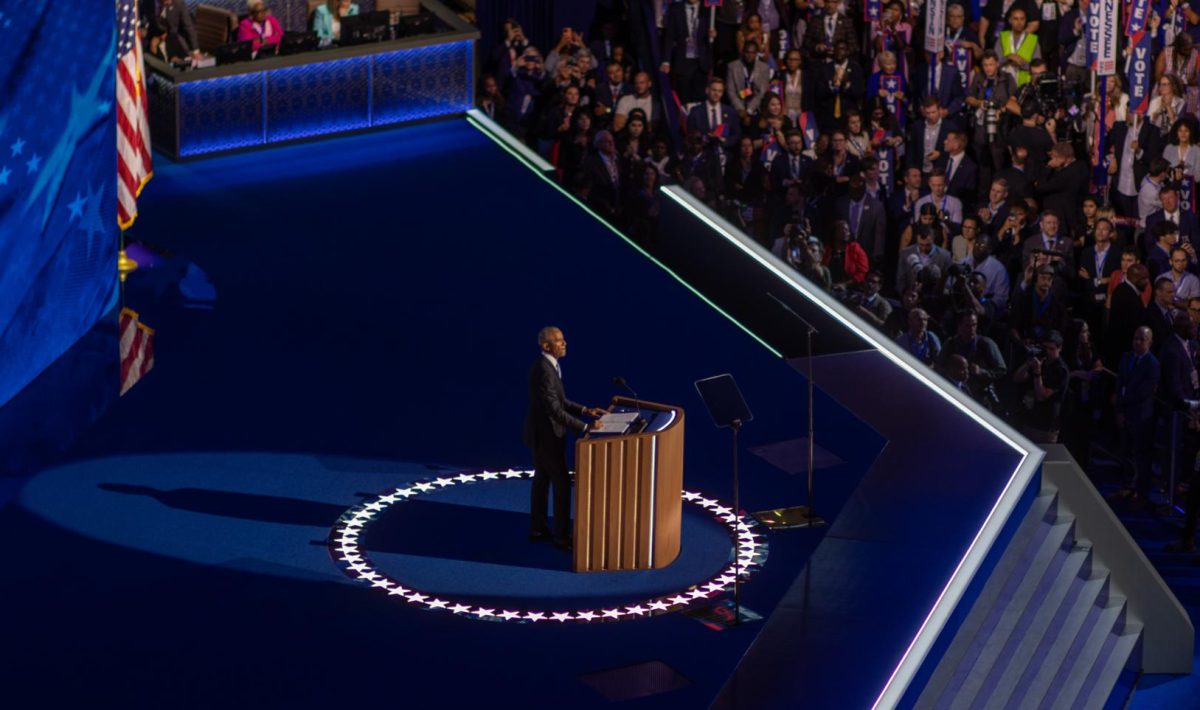 Former President Barack Obama addresses the crowd at the United Center on Tuesday night.