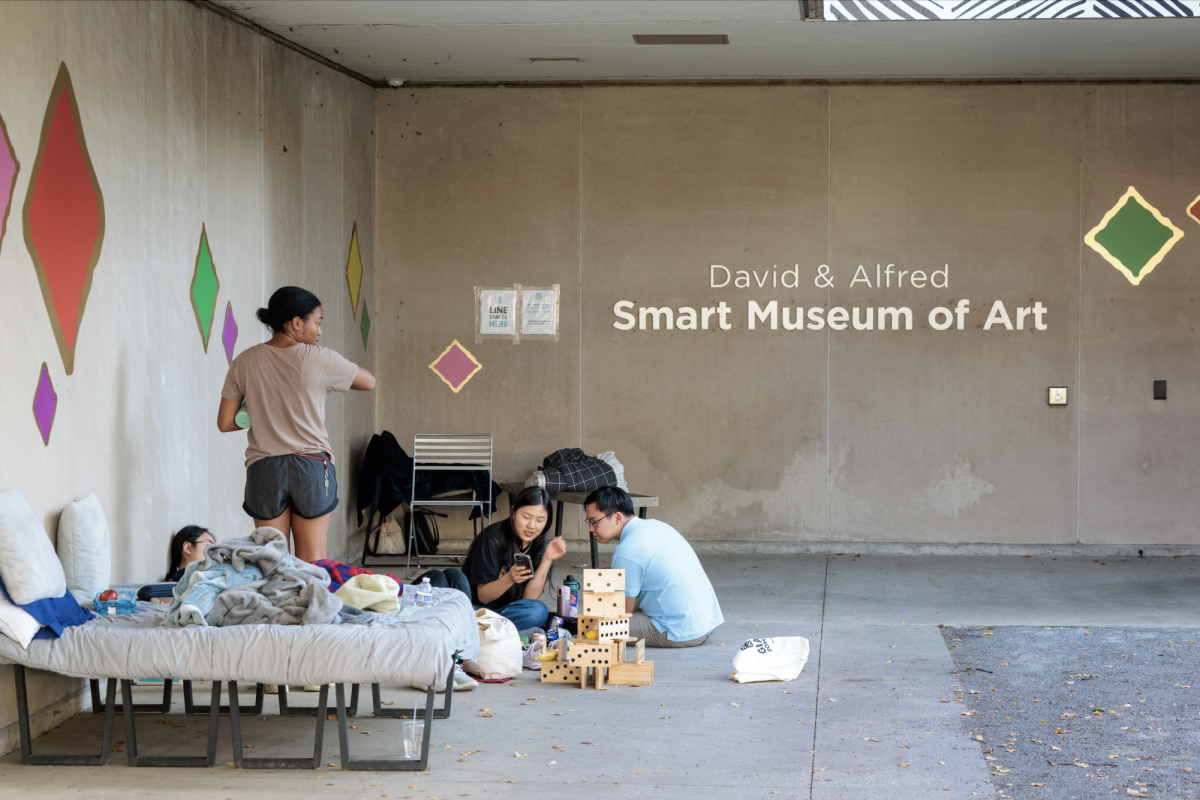 Students wait in the Smart Museum quad between required check-ins the day before the event. 