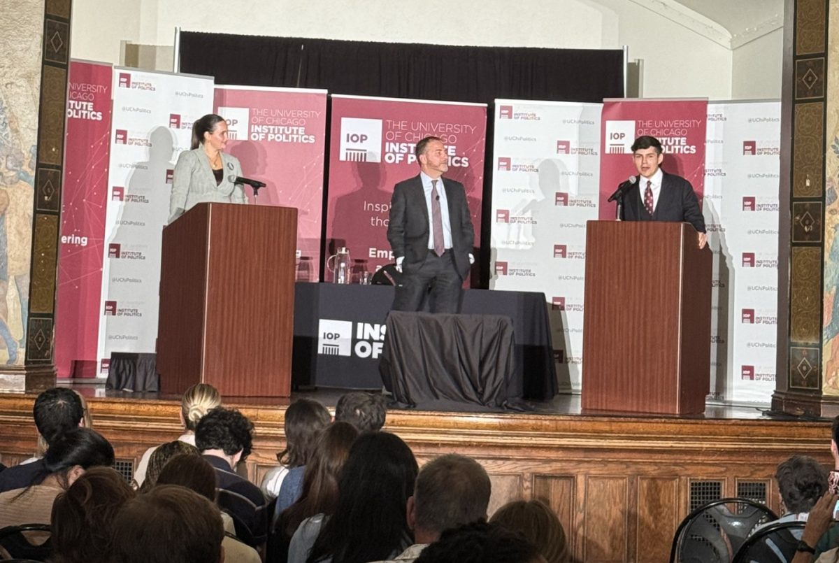 Kate Davis (left) and Christopher Phillips (right) debate, moderated by Chuck Todd (center).