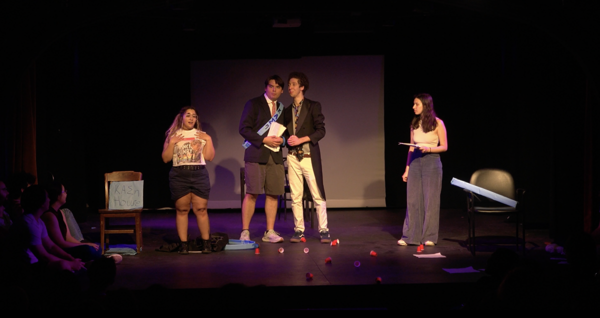 Kassie Rivera (far left) asserts authorship of a fan fiction by reciting it from memory and claims a coveted summer internship from her frat brothers Anthony Stefani (second from right) and Simon Lenoe (second from left).