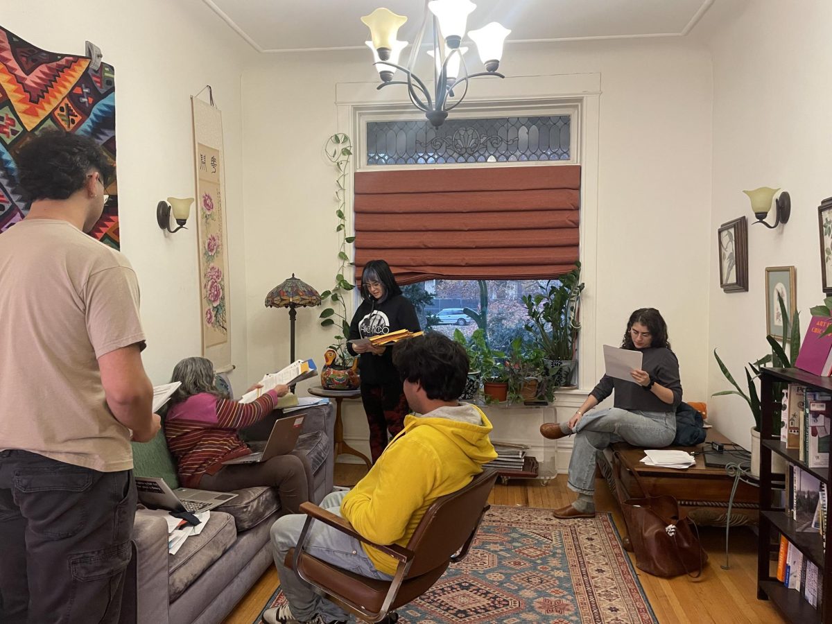 Maureen Graves and legal clinic volunteers work with a migrant on his asylum application in Graves’ living room.
