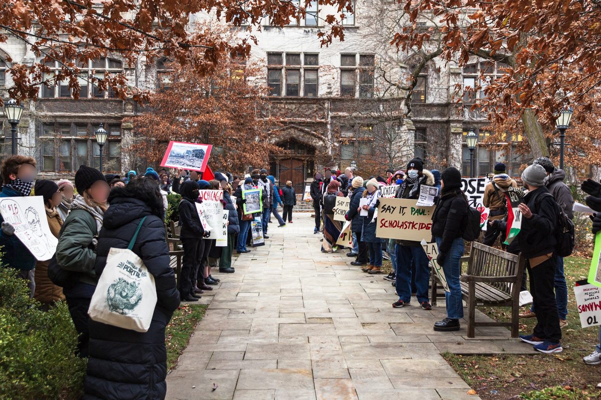 Protesters rally outside of Stuart Hall on both sides of the path through the center of Harper Quad.