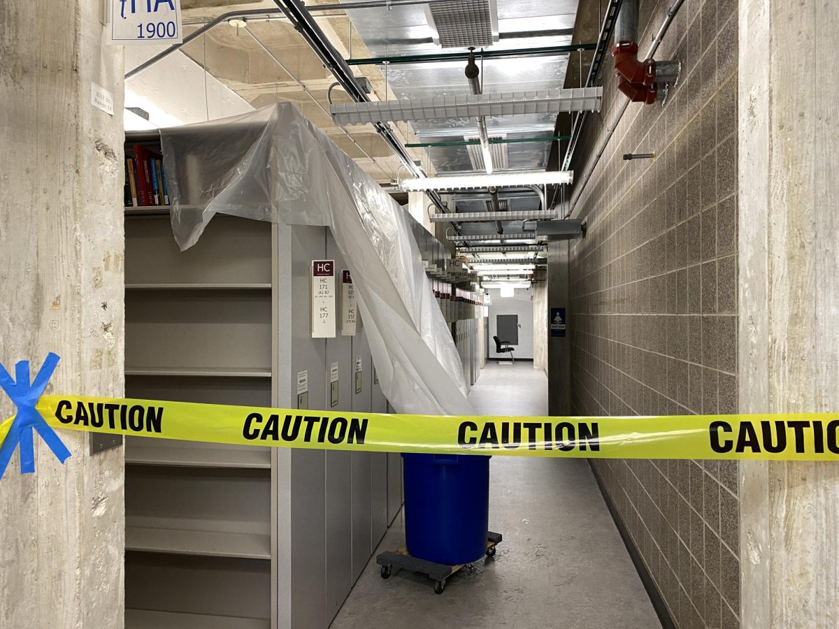 Plastic sheeting draped over shelves on the B-level protects books from leaking water. 