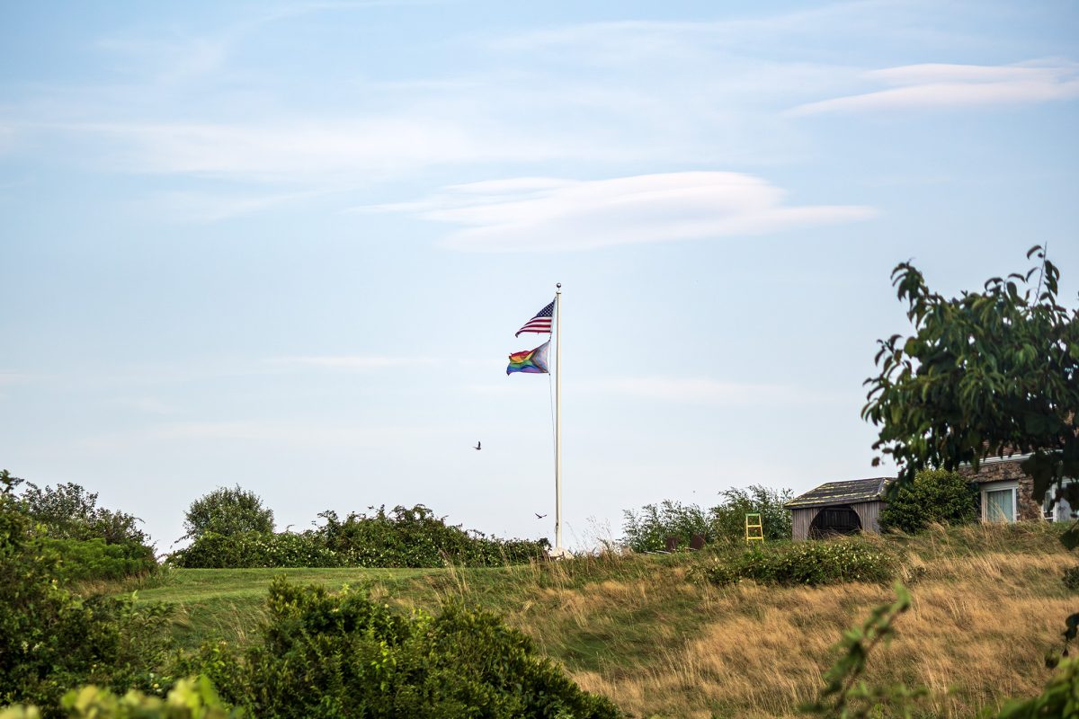 An American flag and a Pride flag fly together in New Shoreham, R.I.