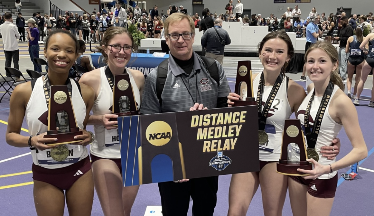 Members of UChicago's national champion distance medley relay team, joined by head coach Chris Hall (center) included (from left): Ren Brown, Nora Holmes, Claudia Harnett and Emma Kelly. 