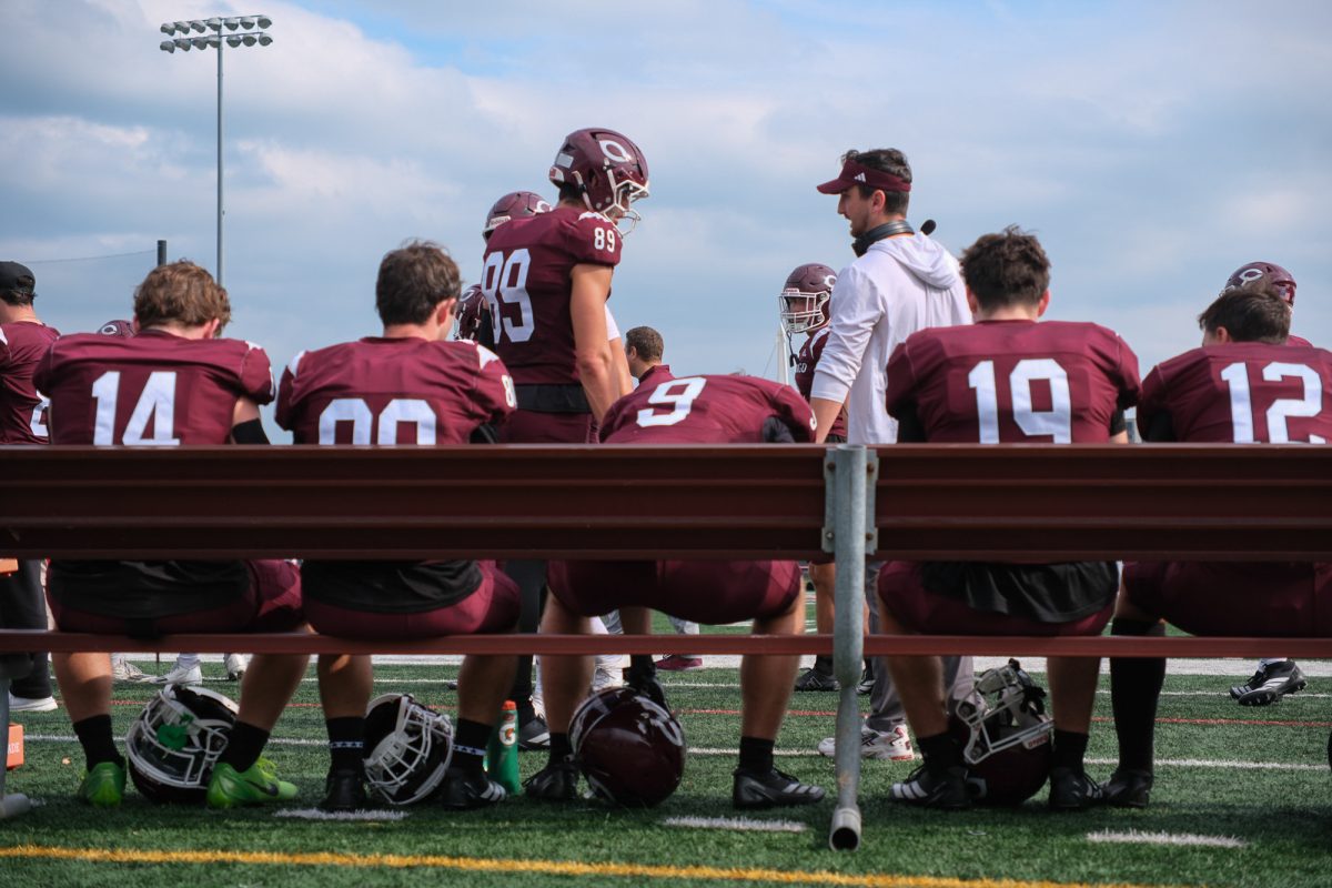 The Maroons on the bench during a break in the game.