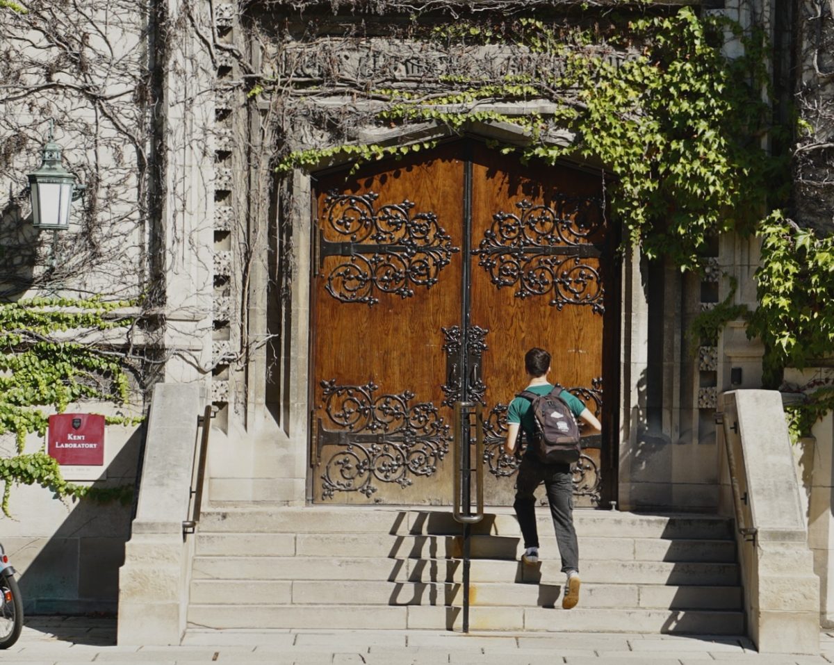 A student walks up the steps of Kent Chemical Laboratory.