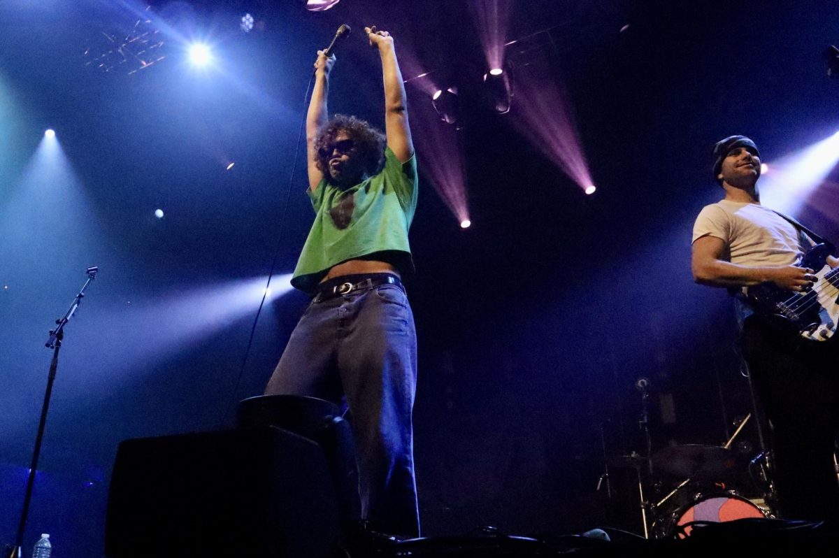 Dawson Daugherty (left), known for his energetic dance moves, strikes a playful pose mid-song as Luke Fabry (right) beams at the crowd.
