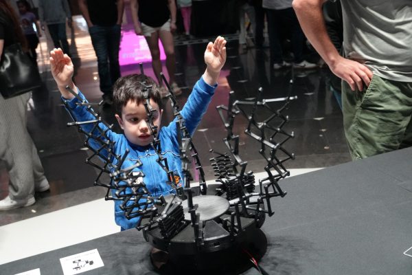 A child experiences actuation with a demonstration of the Xs sculpture at the Robot Block Party 2024. Courtesy of the AxLab.