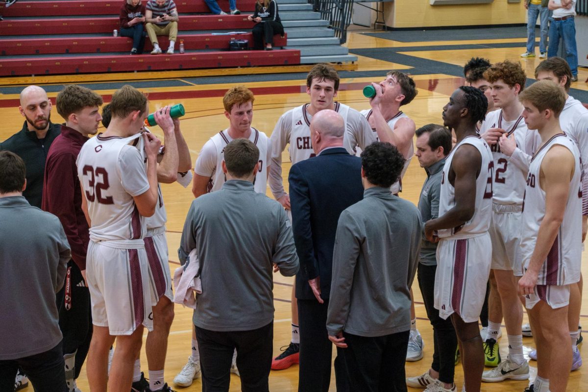 Head men’s basketball coach Mike McGrath talks to the team during a timeout.