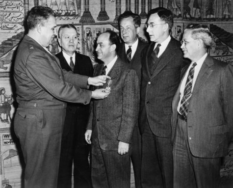The director of the Manhattan District awards physicist Enrico Fermi and other University scientists Medals of Merit for their role in the successful development of the atomic bomb. Courtesy of the Hanna Holborn Gray Special Collections Research Center.