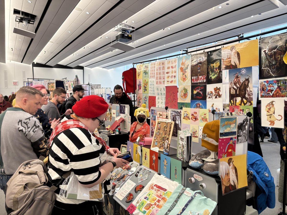 Community members buy merchandise from one of the many stalls at the artists alley. 