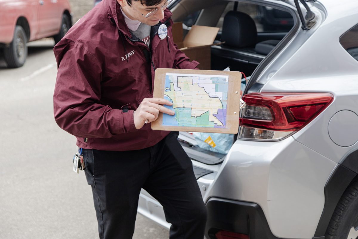 Knapp shows the canvassers a map of Illinois’s 13th state house district.