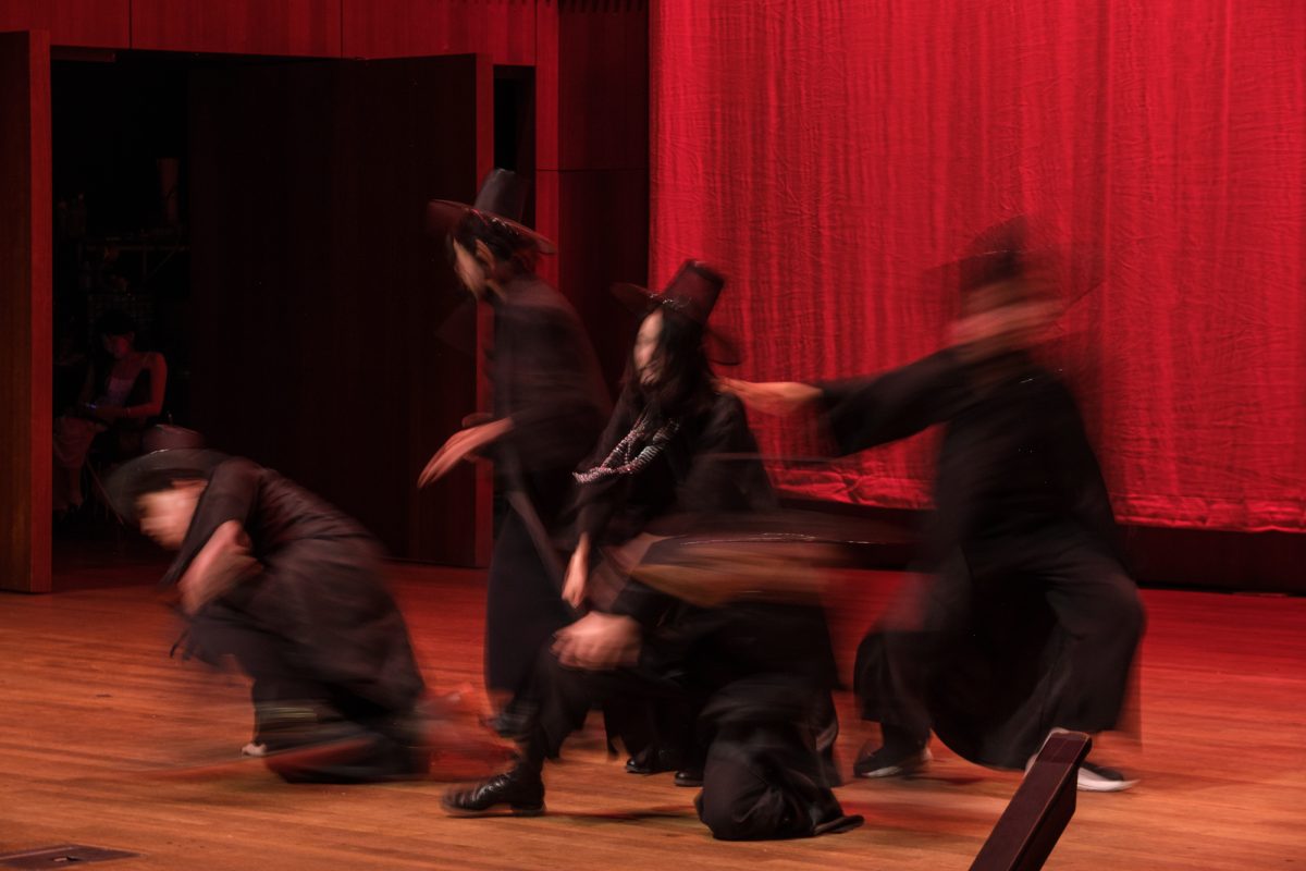 Members of Nexus perform a routine to a song from K-Pop Demon Hunters dressed as jeoseung saja, Korean demons.