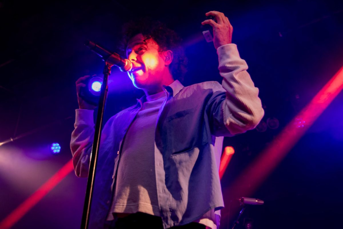 Lead vocalist Max Kerman holds up beam lights as he performs at Bottom Lounge.