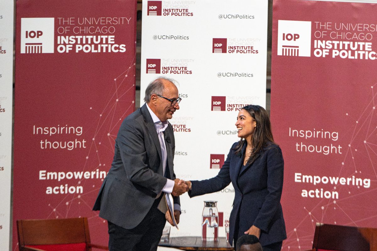 Axelrod and Ocasio-Cortez shake hands following their conversation.