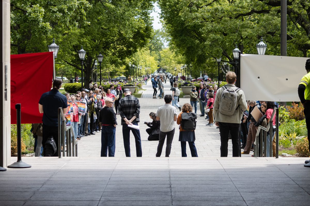 Faculty and staff gather on the steps and walkway outside of Levi Hall on Friday, May 15.