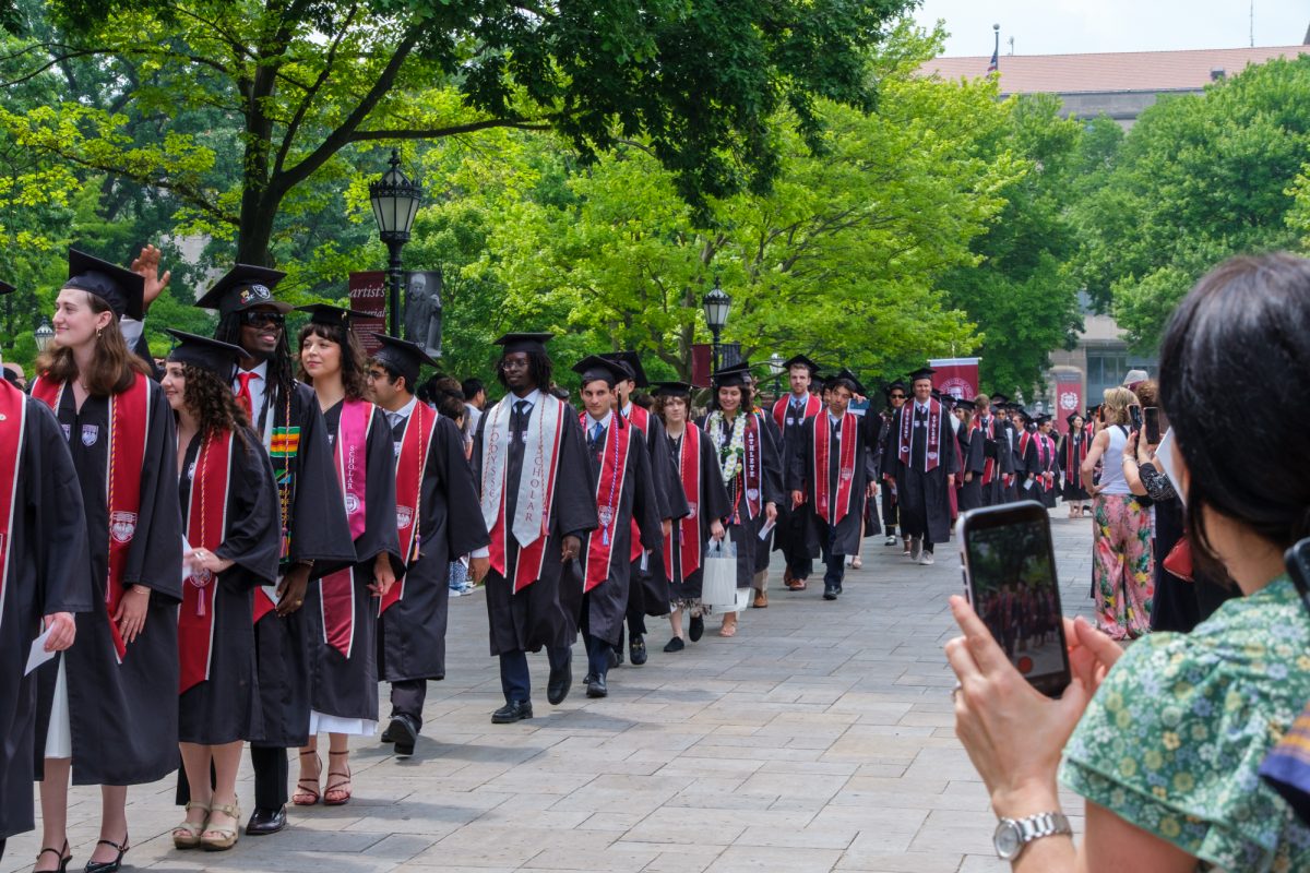 College graduates from Max Palevsky Residential Commons make their way through the main quad before receiving their diplomas.