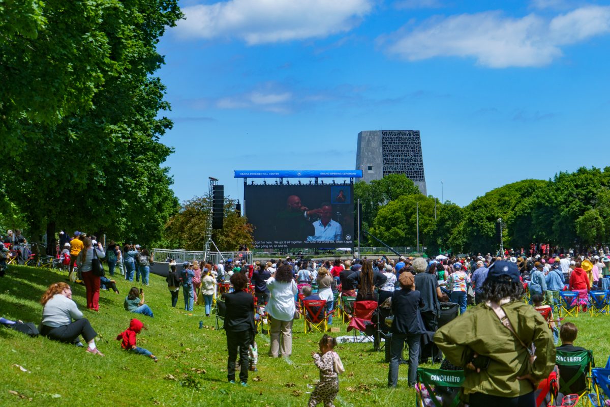 Attendees on the Midway Plaisance watch Stevie Wonder’s “Higher Ground,” the event's final musical performance.