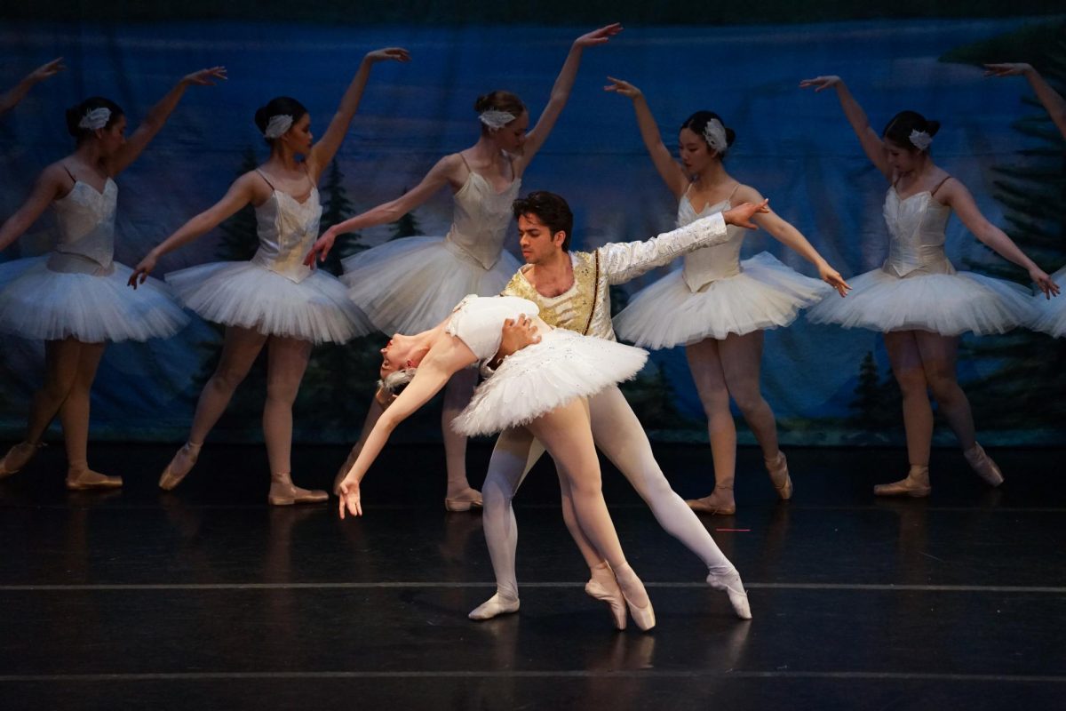 Bridget Curtis (J.D. ’26) as Odette bends into the arms of Ian Palmer (A.M. ’24) as Prince Siegfried. Courtesy of Hannah Brody.